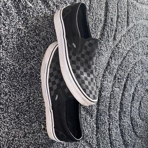 Black on black checkered slip on vans